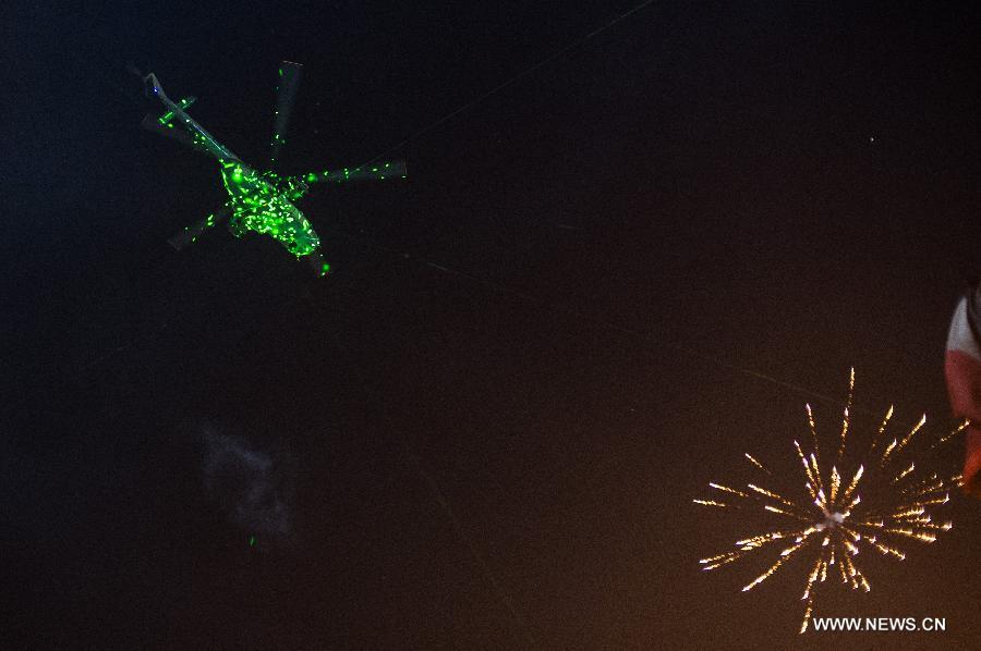 A military helicopter flies over Cairo's Tahrir Square, Egypt, on July 3, 2013. Egyptian interior ministry expressed complete support to a military statement that revealed a roadmap for running the country after the ouster of Islamist President Mohamed Morsi, the ministry said in a statement Wednesday. (Xinhua/Li Muzi)