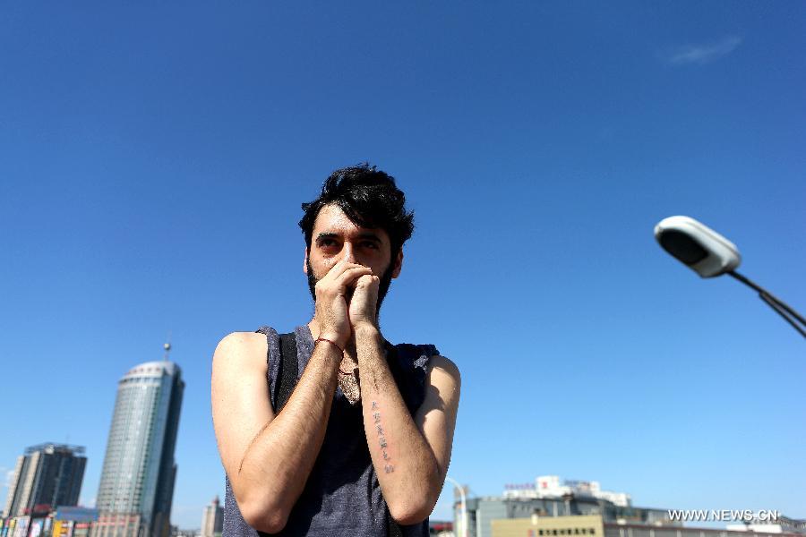 Juan Gonzalez Zamora shows his tattoo reading "The sky is blue" on his arm in Beijing, capital of China, July 2, 2013. Juan, a Spanish artist, came to Beijing three months ago. The past three months witnessed his discontent to the air quality in Beijing as well as his love for the city. As an artist, he wanted to find some way to carry his wish for the blue sky and clean air. Juan turned to Chen Gong, a famous tattoo artist, asking Chen to create a tattoo using Chinese characters and blue pigment on his arm. The tattoo is composed of six Chinese characters meaning "The sky is blue". Juan hoped that "The sky is blue" is not only carved on his arm, but also able to become a reality and to last forever. (Xinhua/Zhang Chuanqi)