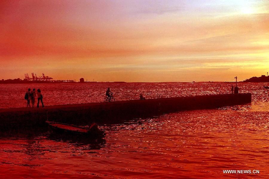 Photo taken on July 3, 2013 shows the scenery of sunset at the "fisherman's wharf" in Danshui, Xinbei, southeast China's Taiwan. Dubbed as the "Oriental Venice", Danshui is a pop scenery spot for tourists. (Xinhua/Tao Ming)