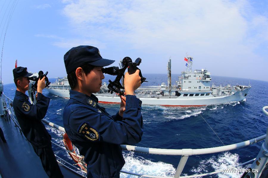 The soldiers from destroyer Shenyang observe the distance between two vessels during Sino-Russian joint naval drills held in the sea of Japan, July 4, 2013. (Xinhua/Zha Chunming) 