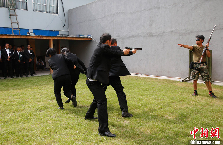 Trainees receive the tactical shooting training during a VIP security training course in Lianyungang, east China's Jiangsu province, June 30, 2013. (Chinanews/Liu Guanguan)