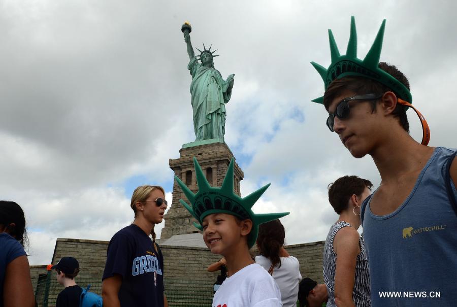 People visit the Statue of Liberty at Liberty Island in New York, the United States, on July 4, 2013, the U.S. Independence Day. The Statue of Liberty and Liberty Island reopened to the public on Thursday for the first time since Hurricane Sandy made landfall on Oct. 29, 2012. (Xinhua/Wang Lei) 