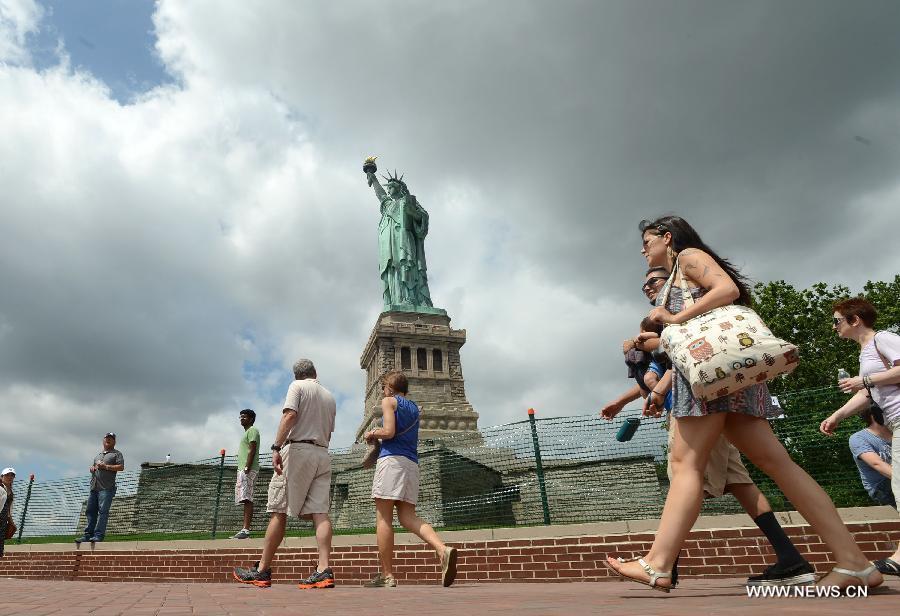 People visit the Statue of Liberty at Liberty Island in New York, the United States, on July 4, 2013, the U.S. Independence Day. The Statue of Liberty and Liberty Island reopened to the public on Thursday for the first time since Hurricane Sandy made landfall on Oct. 29, 2012. (Xinhua/Wang Lei) 