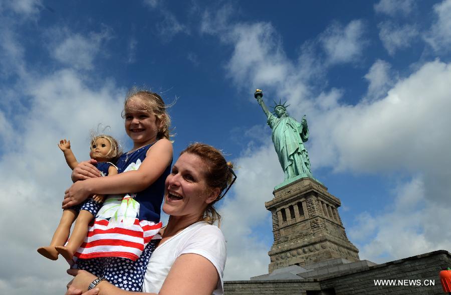 People visit the Statue of Liberty at Liberty Island in New York, the United States, on July 4, 2013, the U.S. Independence Day. The Statue of Liberty and Liberty Island reopened to the public on Thursday for the first time since Hurricane Sandy made landfall on Oct. 29, 2012. (Xinhua/Wang Lei) 