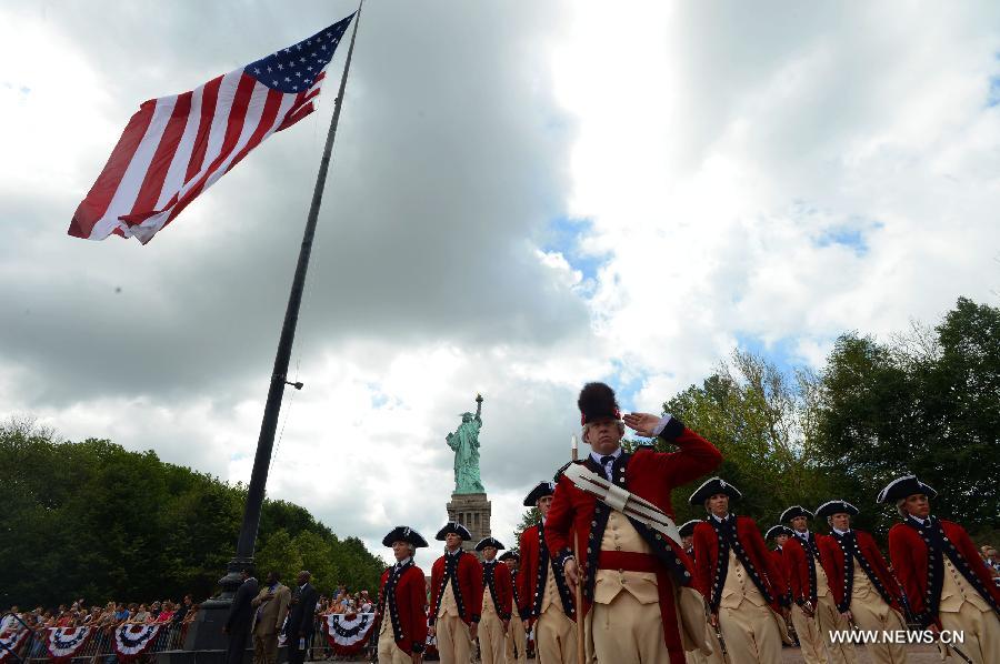 Members of the Old Guard attend the reopening ceremony of the Statue of Liberty at Liberty Island in New York, the United States, on July 4, 2013, the U.S. Independence Day. The Statue of Liberty and Liberty Island reopened to the public on Thursday for the first time since Hurricane Sandy made landfall on Oct. 29, 2012. (Xinhua/Wang Lei)