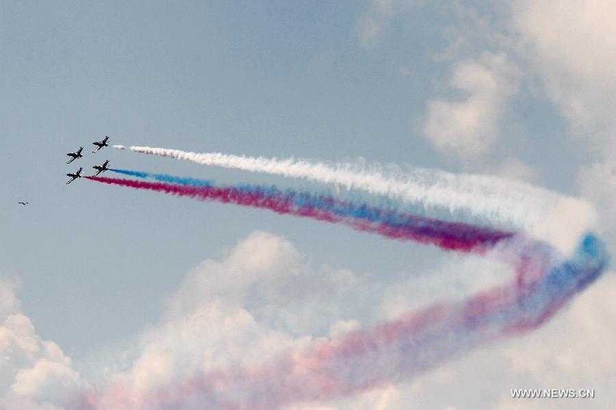 Aircrafts from Russia's MIG aerobatics team perform during the 6th International Maritime Defence Show in St.Petersburg, Russia, on July 4, 2013. The aerobatic teams will entertain crowds at the 6th International Maritime Defence Show to be held here from July 3-7. (Xinhua/Lu Jinbo)