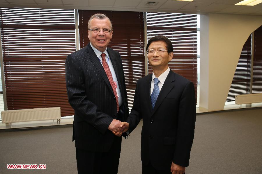 Meng Jianzhu (R), a member of the Political Bureau of the Communist Party of China (CPC) Central Committee and secretary of the Commission for Political and Legal Affairs of the CPC Central Committee, meets with Yuri Fedotov, chief of United Nation Office on Drugs and Crime, in Vladivostok, Russia, on July 2, 2013. (Xinhua/Hao Fan)