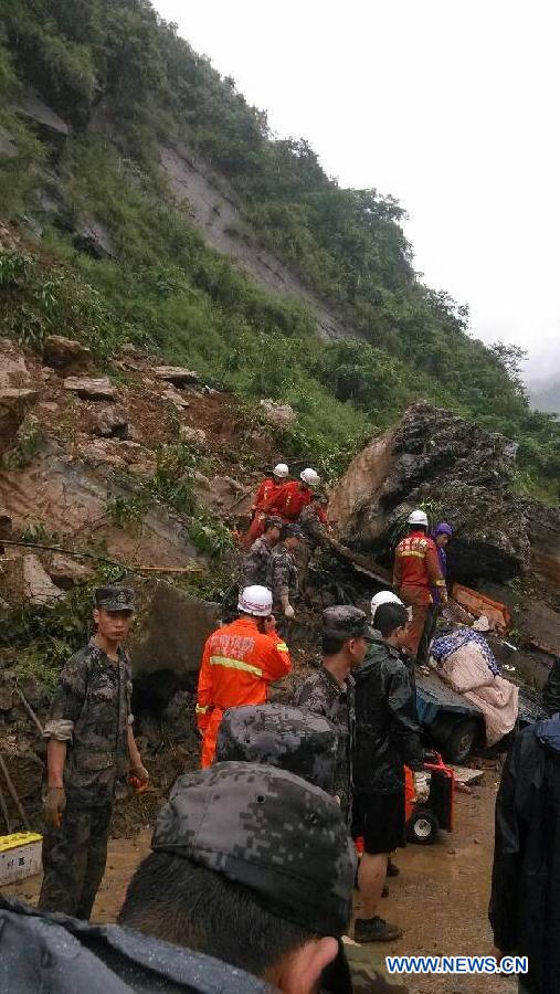 Rescuers search for survivors after a landslide in Gaoqiao Village of Yanjin County in Zhaotong City, southwest China's Yunnan Province, July 5, 2013. Nine people were buried by the landslide which happened on Friday morning. Four of them have been saved, while the other five are still missing. The rescue operation is underway. (Xinhua/Yuan Zhengxiong) 