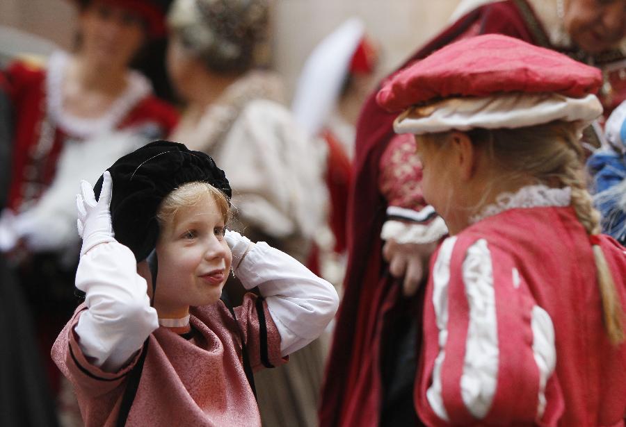 A young performer in ancient costume waits to take part in the annual procession of Ommegang at the Grand Place of Brussels, capital of Belgium, July 4, 2013. More than 1,000 performers took part in Ommegang, Brussels' traditional annual pageant, to reenact the entry of Holy Roman Emperor Charles V to Brussels in 1549. (Xinhua/Zhou Lei) 