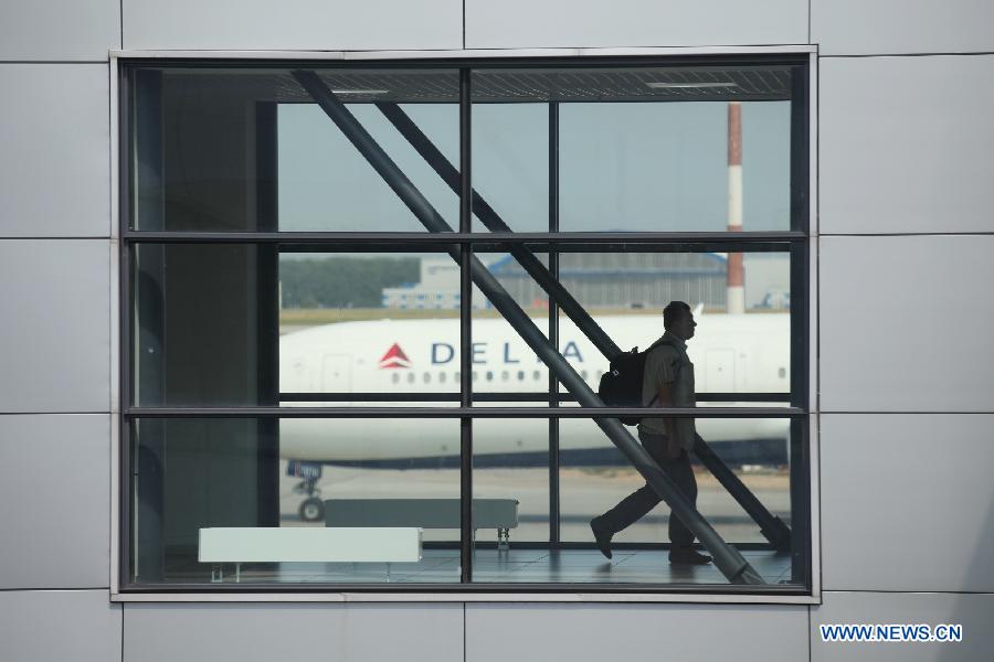 A passenger walks in the transit area between Terminal D and E at Moscow's Sheremetyevo International Airport, Russia, July 5, 2013. Snowden, via his legal advisor Sarah Harrison from WikiLeaks, earlier this week handed over an asylum request to Russian authorities but withdrew it later. He fled to Moscow from Hong Kong and has reportedly stayed since June 23 in the transit area of Moscow's Sheremetyevo airport. (Xinhua/Liu Yiran) 