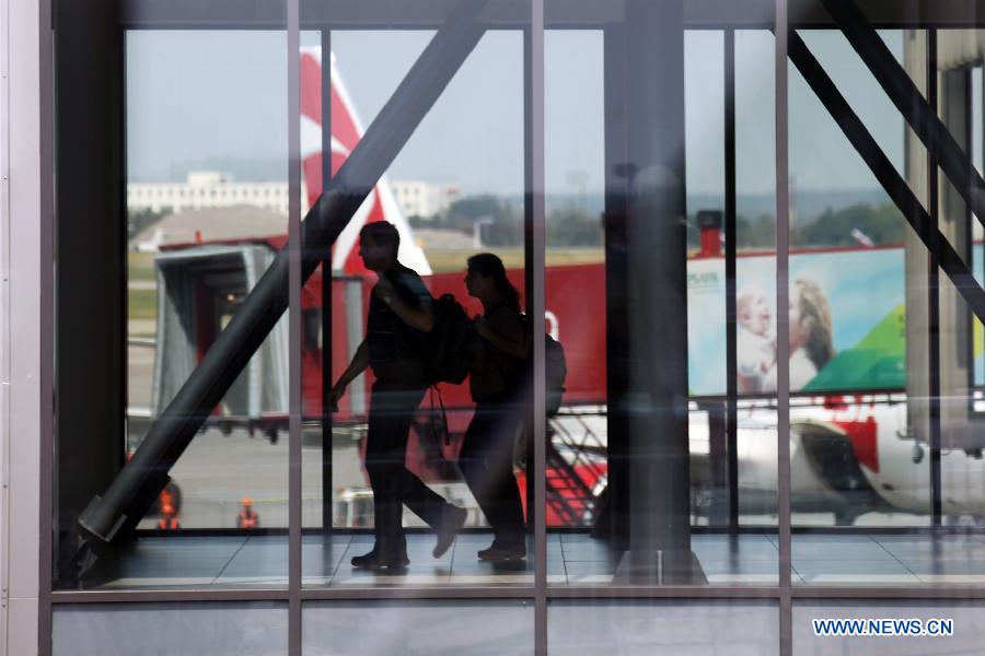 Passengers walk in the transit area between Terminal E and F at Moscow's Sheremetyevo International Airport, Russia, July 5, 2013. Snowden, via his legal advisor Sarah Harrison from WikiLeaks, earlier this week handed over an asylum request to Russian authorities but withdrew it later. He fled to Moscow from Hong Kong and has reportedly stayed since June 23 in the transit area of Moscow's Sheremetyevo airport. (Xinhua/Liu Yiran)