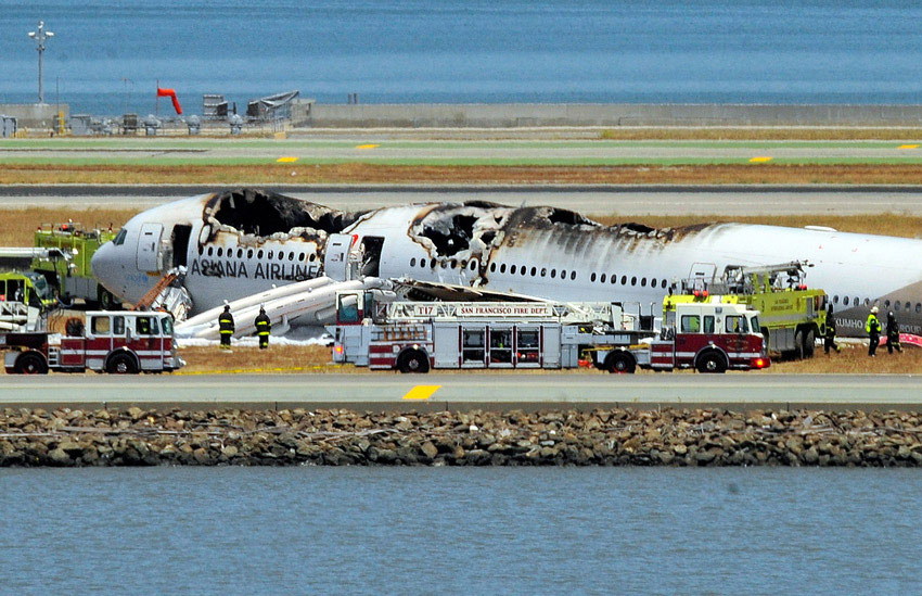 Fire crews work at the crash site at San Francisco International Airport on July 6. (Xinhua/AFP)