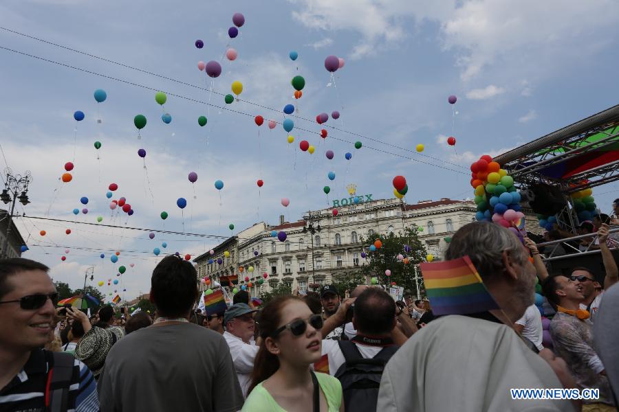 Participants release balloons with their wishes attached to them as they march across the city during the Gay Pride Parade in Budapest, Hungary on July 6, 2013. (Xinhua/Attila Volgyi) 