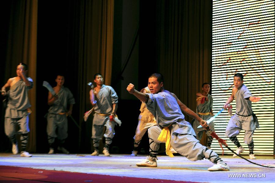 Performers of the Yandong Shaolin Kungfu troupe show their Kungfu during a performance held at the Worker's Cultural Palace, Taiyuan, capital of north China's Shanxi Province, July 6, 2013. The martial art troupe have their performers trained in the renowned Shaolin Temple, and staged performances worldwide in the hope of promoting Shaolin-style martial arts and Chinese culture. (Xinhua/Fan Minda)  