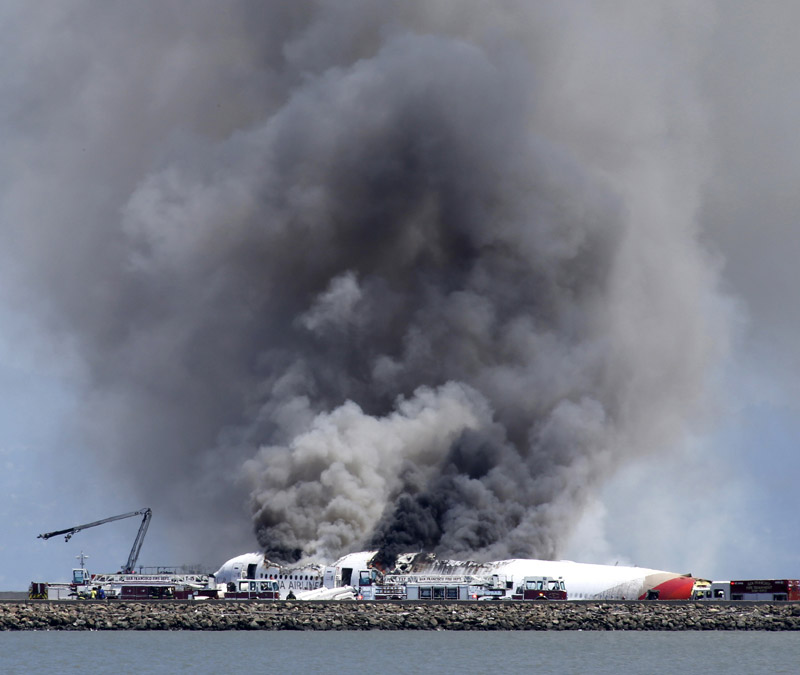 Fire crews work at the crash site at San Francisco International Airport on July 6. (Xinhua/AFP)