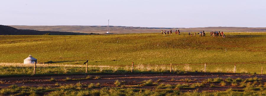 Photo taken on July 1, 2013 shows the scenery of a grassland near Hohhot, capital of north China's Inner Mongolia Autonomous Region. Inner Mongolia has entered its tourism peak season recently. (Xinhua/Shang Jun)