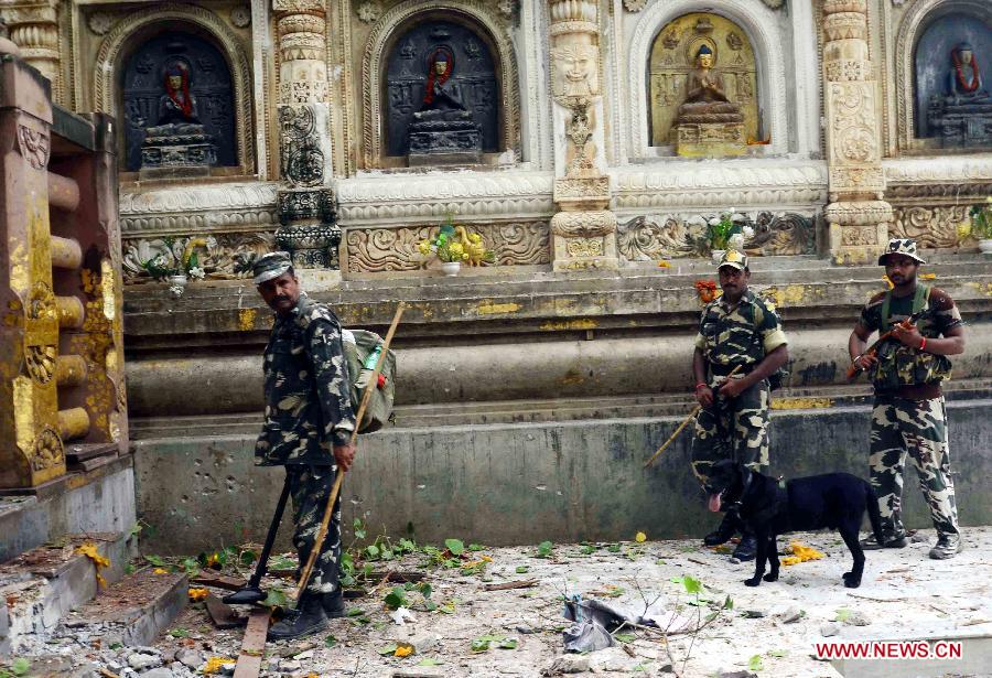 Security officers inspect the site of an explosion on the campus of the Mahabodhi Temple, the Buddhist Great Awakening temple, in Bodhgaya, about 130 kilometers (80 miles) south of Patna, the capital of the eastern Indian state of Bihar, July 7, 2013. A series of small blasts hit three Buddhist temples in eastern India early Sunday, injuring at least two people, police said. (Xinhua)