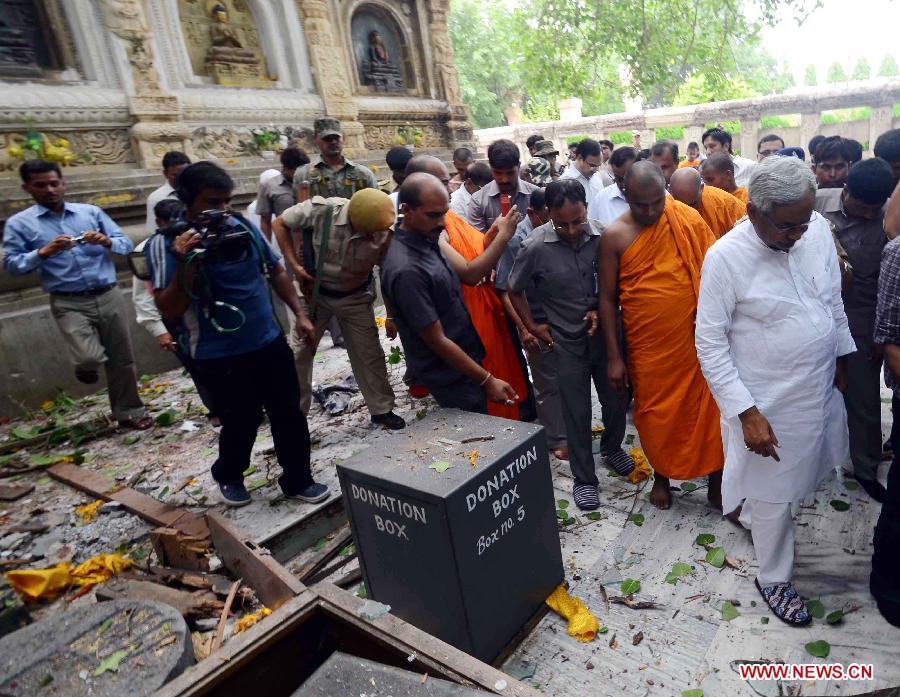 Bihar Chief Minister Nitish Kumar (1st R, front) and others inspect the site of an explosion on the campus of the Mahabodhi Temple, the Buddhist Great Awakening temple, in Bodhgaya, about 130 kilometers (80 miles) south of Patna, the capital of the eastern Indian state of Bihar, July 7, 2013. A series of small blasts hit three Buddhist temples in eastern India early Sunday, injuring at least two people, police said. (Xinhua)