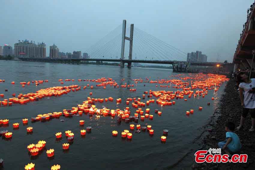 River lanterns float on the Songhua River in Northeast China's Jilin Province, July 7, 2013. Altogether 14,630 lanterns were released in the river, setting a new Guinness World Record.  (CNS/Cang Yan)