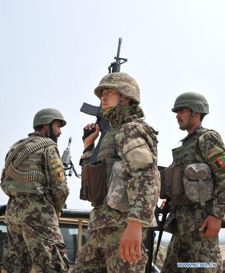 Afghan army soldiers are seen on a military vehicle during an operation against Taliban in Laghman province in eastern of Afghanistan on July 7, 2013. At least five Taliban fighters killed by Afghan army soldiers during an operation in Laghman province on Sunday Army officials said. (Xinhua/Tahir Safi)