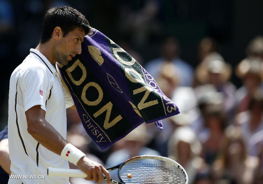 Novak Djokovic of Serbia reacts during the final of gentlemen's singles against Andy Murray of Great Britain on day 13 of the Wimbledon Lawn Tennis Championships at the All England Lawn Tennis and Croquet Club in London, Britain, on July 7, 2013. (Xinhua/Wang Lili)