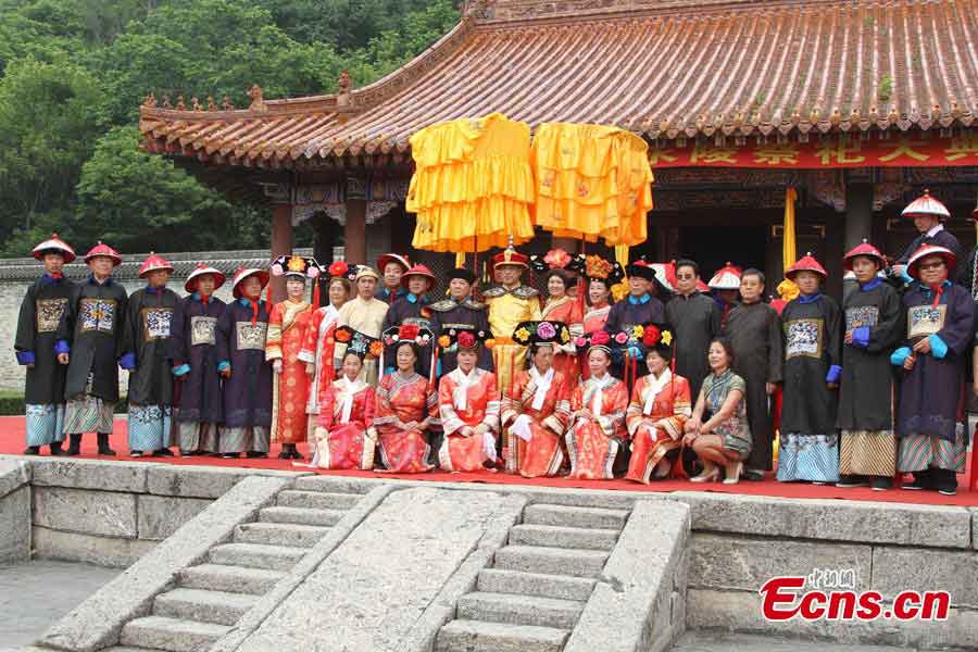 The Aisin Gioro family, who are imperial descendants of the Qing Dynasty (1644–1911), and over 60 Manchu ethnic people pose for photos at the World Heritage Yongling Tomb in Fushun, Liaoning Province, July 7, 2013. They held a ceremony to worship their ancestors on Sunday. (CNS/Cao Lichun)