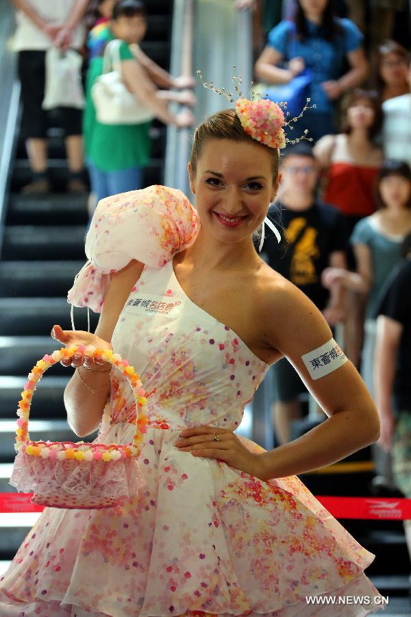 A model presents headwear as well as a dress made of candies, designed by Hong Kong designer Lilian Kan at Citygate Outlets in south China's Hong Kong, July 8, 2013. Kan showed her self-designed shoes and apparels made of candies here on Monday. (Xinhua/Li Peng)
