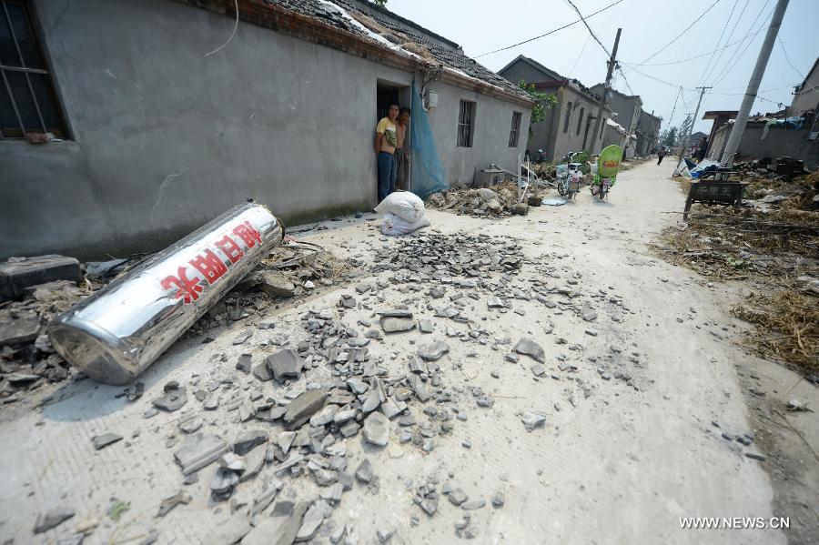 Photo taken on July 8, 2013 shows broken tiles after a tornado in Yuhu Village, Gaoyou City, east China's Jiangsu Province. Tornados battered Gaoyou and Yizheng in the province on July 7, making houses and power devices damaged. (Xinhua/Meng Delong)