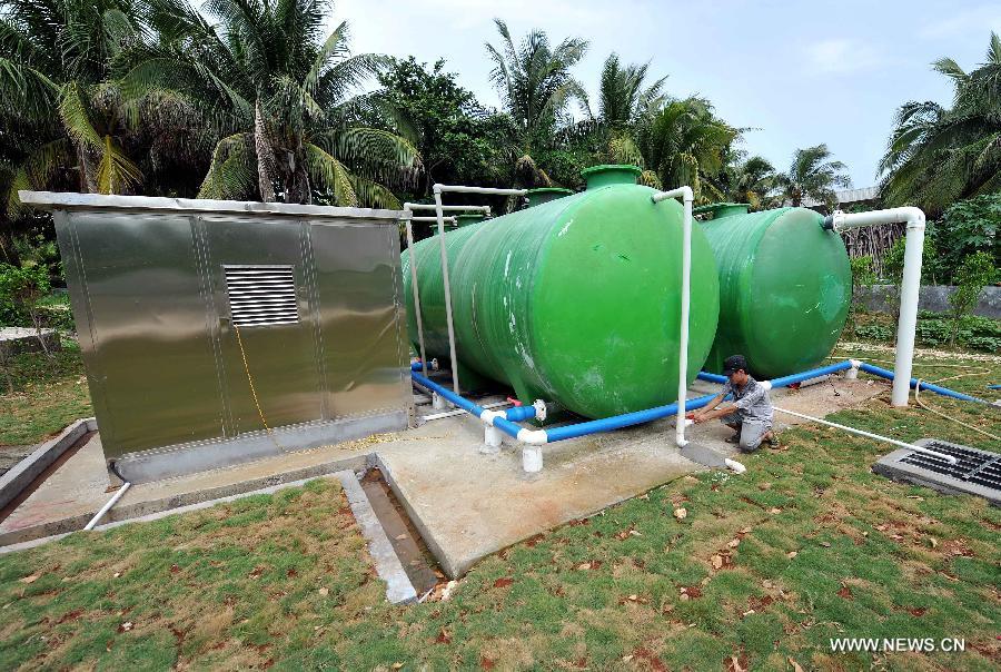 A man works for the first phase project of the Yongxing Island Sewage Treatment Plant in Sansha City, south China's Hainan Province, July 7, 2013. Within one year after its establishment, infrastructure construction is going on well in Sansha. The first phase project of the Yongxing Island Sewage Treatment Plant and a seawater desalination factory has been put into use. The power grid transformation is in progress. And the Xisha People's Hospital is under construction. (Xinhua/Guo Cheng)