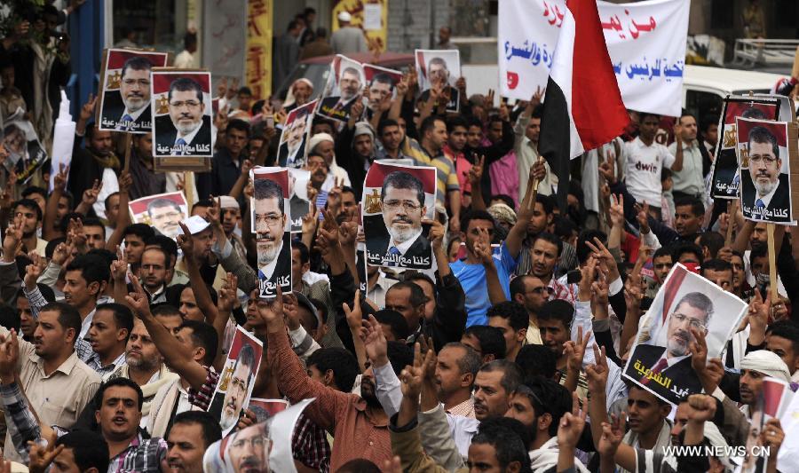 Yemeni protesters hold posters of ousted Egyptian President Mohamed Morsi during a rally at al-Tahrir Square in Sanaa, Yemen, on July 8, 2013. Thousands of Yemeni supporters of Mohamed Morsi took to streets to condemn Egyptian army's ouster of president. (Xinhua/Mohammed Mohammed)