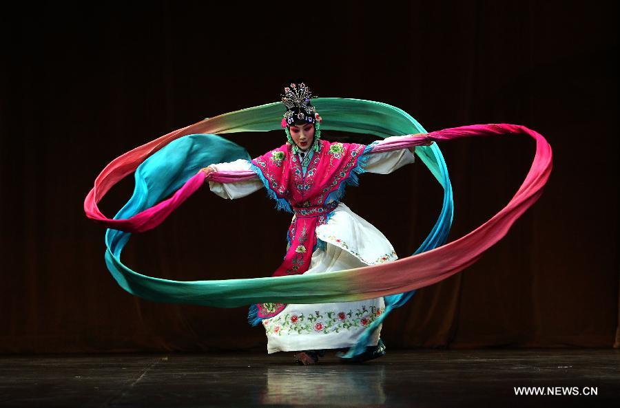 A Chinese artist performs Beijing Opera at the National Theater in Algiers, capital of Algeria, July 8, 2013. The performance was part of the celebrations to mark the 55th anniversary of the establishment of the diplomatic relations between China and Algeria. (Xinhua/Mohamed Kadri) 