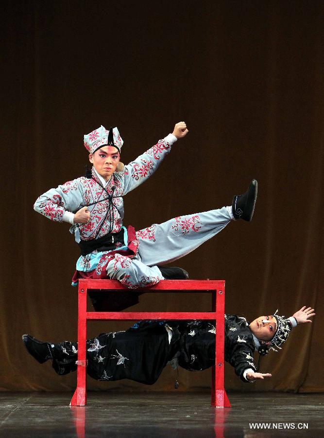 A Chinese artist performs Beijing Opera at the National Theater in Algiers, capital of Algeria, July 8, 2013. The performance was part of the celebrations to mark the 55th anniversary of the establishment of the diplomatic relations between China and Algeria. (Xinhua/Mohamed Kadri) 