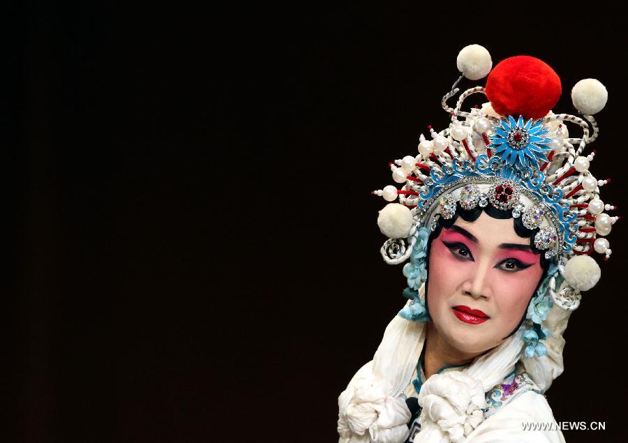 A Chinese artist performs Beijing Opera at the National Theater in Algiers, capital of Algeria, July 8, 2013. The performance was part of the celebrations to mark the 55th anniversary of the establishment of the diplomatic relations between China and Algeria. (Xinhua/Mohamed Kadri) 