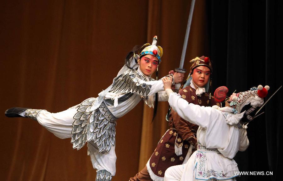 Chinese artists perform Beijing Opera at the National Theater in Algiers, capital of Algeria, July 8, 2013. The performance was part of the celebrations to mark the 55th anniversary of the establishment of the diplomatic relations between China and Algeria. (Xinhua/Mohamed Kadri)