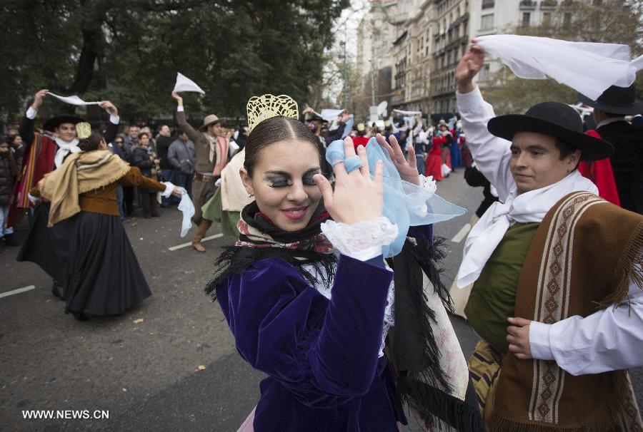 Couples dressed with traditional costumes participate in a parade during the celebration of Independence Day, in Buenos Aires, Argentina, on July 9, 2013. (Xinhua/Martin Zabala)