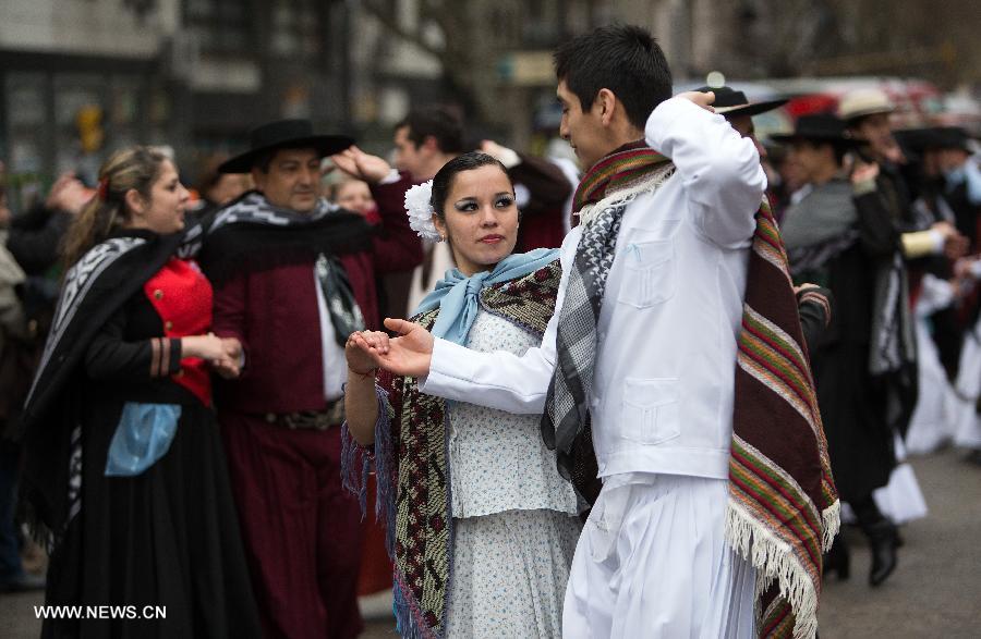 Couples dressed with traditional costumes participate in a parade during the celebration of Independence Day, in Buenos Aires, Argentina, on July 9, 2013. (Xinhua/Martin Zabala)