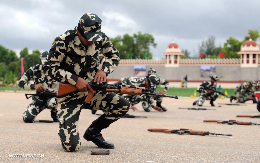 Central Reserve Police Force (CRPF) personnels participate in an arms drill during the passing-out parade of 945 recruits in Bangalore, India, on July 9, 2013. (Xinhua/Stringer) 