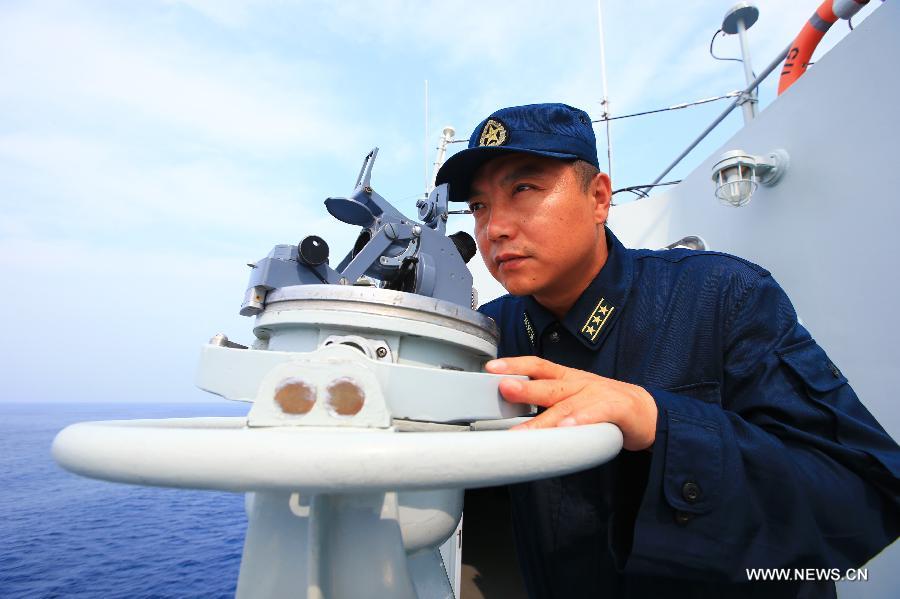 Zhang Changlong, Captain of guided-missile destroyer Shenyang, attends the "Joint Sea-2013" drill at Peter the Great Bay in Russia, July 9, 2013. Chinese and Russian warships carried out a variety of exercises including joint air defense, maritime supply, joint escort and the rescue of hijacked vessels during the second day of "Joint Sea-2013" drill. (Xinhua/Zha Chunming)