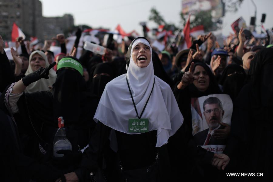 Egyptian supporters of ousted president Mohamed Morsi rally during a funeral of protesters killed on the previous day, outside Cairo's Rabaa al-Adawiya mosque on July 9, 2013. Clashes between Islamist protesters and the army in Cairo on July 9 killed at least 51 and injured 435 others. (Xinhua/Wissam Nassar) 