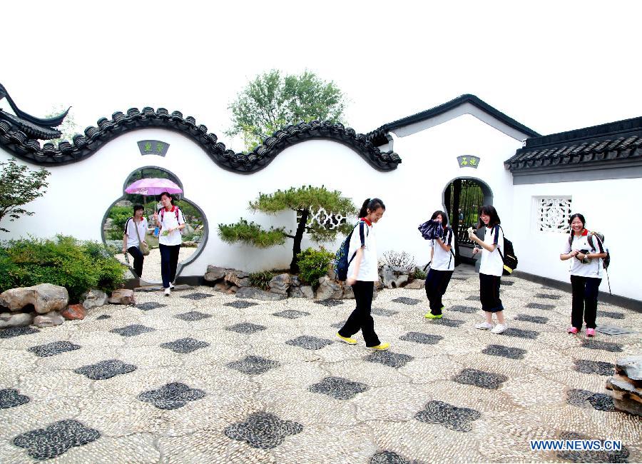 Tourists visit the Garden Expo Park in Beijing, capital of China, July 9, 2013. The 9th China (Beijing) International Garden Expo is held here from May 18 to Nov. 18, 2013. (Xinhua/Wang Xibao)