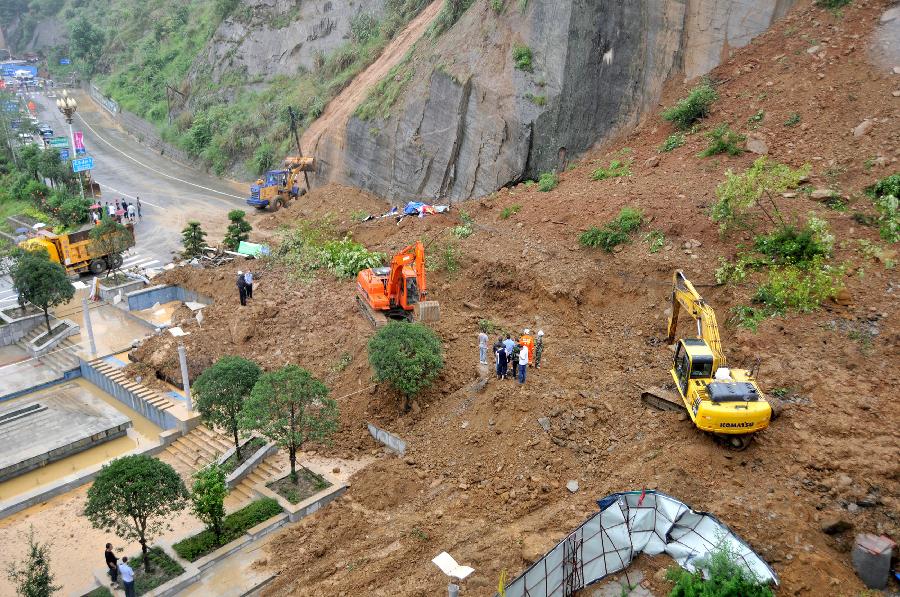 Rescuers work at the mudflow site in Pingwu County of Mianyang City, southwest China's Sichuan Province, July 10, 2013. A section of the Jiuzhaigou ring highway was hit by a mudflow in Pingwu on Wednesday noon. No casualties have been reported yet. Rescue work is under way. (Xinhua/Hu Yu)