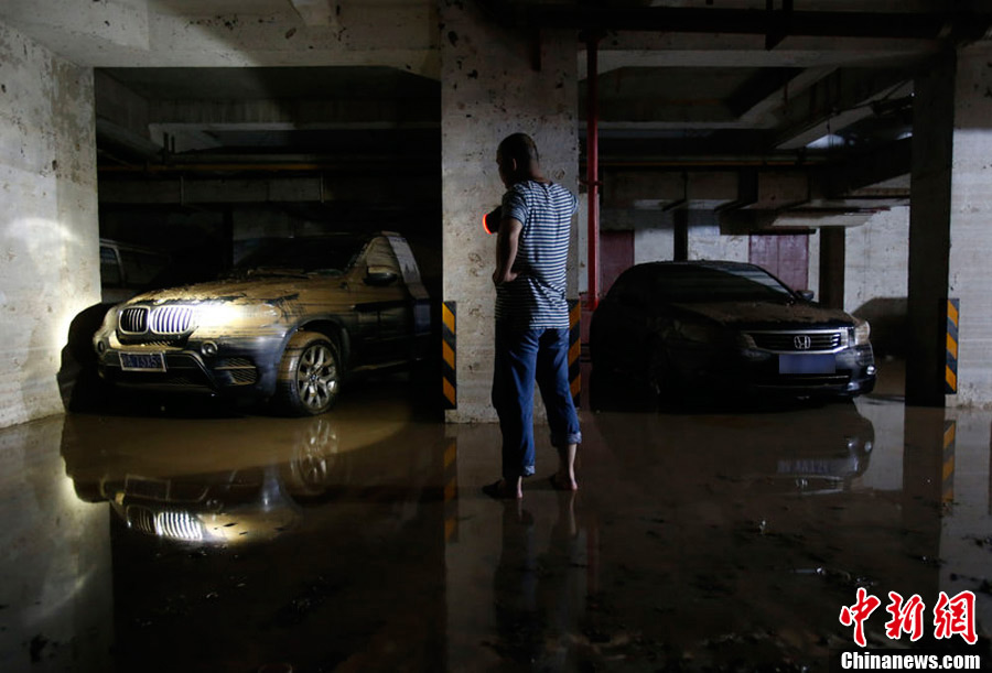 25 cars were stuck in the water in an underground garage of a residential community in Wuhan, capital of central China's Hubei province. (Photo/CNS)