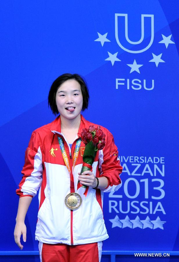 Zheng Shuangxue of China celebrates during the awarding ceremony for the women's 3m Spingboard diving at the 27th Summer Universiade in Kazan, Russia, July 10, 2013. Zheng Shuangxue won the gold medal with 329.25. (Xinhua/Kong Hui)