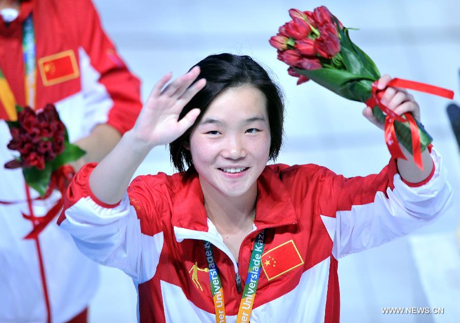 Zheng Shuangxue of China greets spectators after the awarding ceremony for the women's 3m Spingboard diving at the 27th Summer Universiade in Kazan, Russia, July 10, 2013. Zheng Shuangxue won the gold medal with 329.25. (Xinhua/Kong Hui)