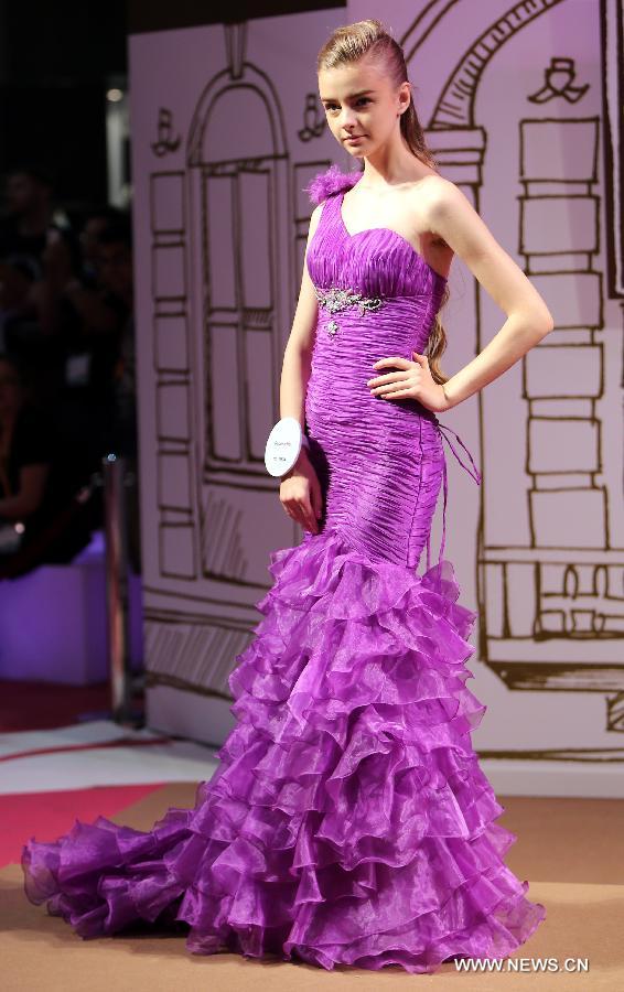 A model presents a creation of a brand at the 20th Hong Kong Fashion Week for Spring/Summer in south China's Hong Kong, July 10, 2013. The four-day fair, which is organized by the Hong Kong Trade Development Council, kicked off at the Hong Kong Convention and Exhibition Center Monday. (Xinhua/Li Peng)