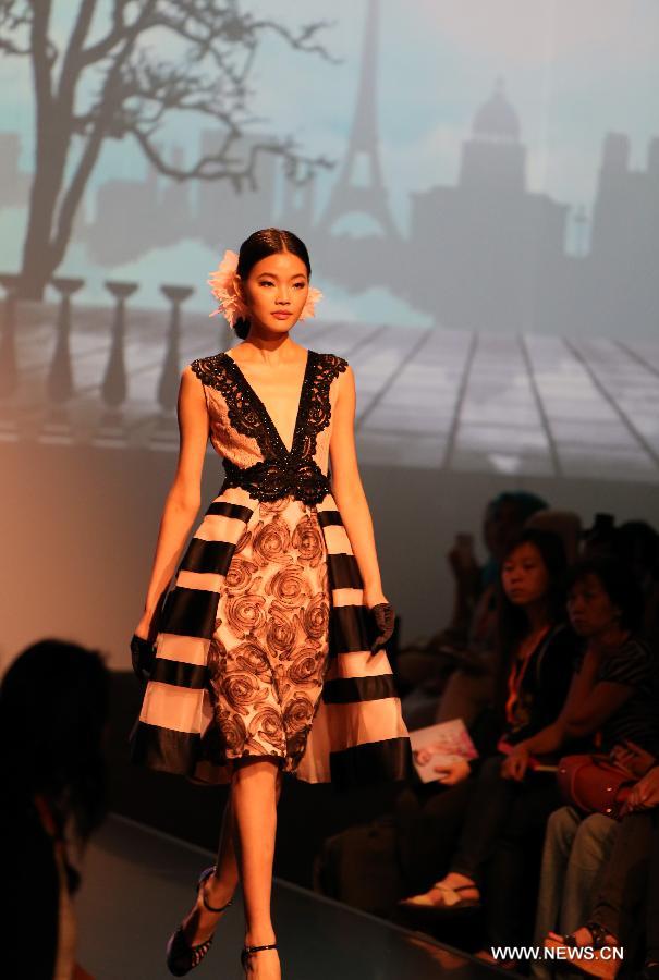 A model presents a creation of a brand at the 20th Hong Kong Fashion Week for Spring/Summer in south China's Hong Kong, July 10, 2013. The four-day fair, which is organized by the Hong Kong Trade Development Council, kicked off at the Hong Kong Convention and Exhibition Center Monday. (Xinhua/Li Peng)