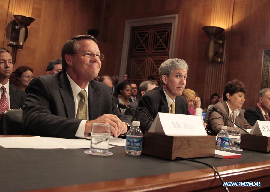 Smithfield Foods CEO Larry Pope (L) attends a hearing of the Senate Committee on Agriculture, Nutrition and Forestry, in Washington, the United States, July 10, 2013. Smithfield Foods CEO Larry Pope on Wednesday tried to relieve Senators' concerns over Chinese Shuanghui International Holdings Ltd.'s purchase of his company. (Xinhua/Wang Zongkai)