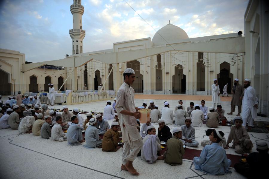 Pakistani Muslim devotees wait to break their fast at a mosque during the first day of the Muslim fasting month of Ramadan in northwest Pakistan's Peshawar on July 11, 2013. Iftar refers to the evening meal when Muslims break their fast during the holly month of Ramadan, a season of fasting and spiritual reflection. (Xinhua/Ahmad Sidique) 