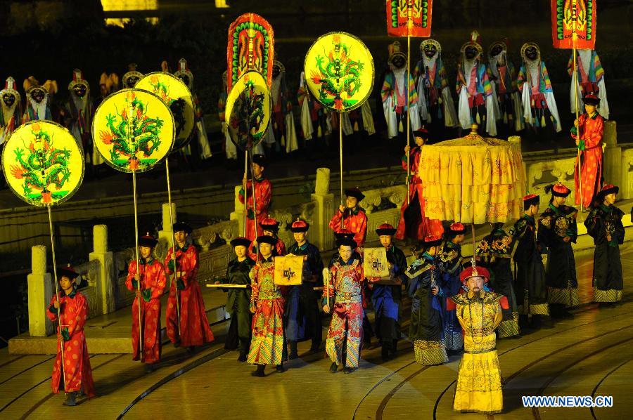 Kangxi ceremony is performed in Chengde, north China's Hebei Province, July 11, 2013. The show depicts the stories of Kangxi (1654-1722), the fourth emperor of ancient China's Qing Dynasty (1644-1911). During the reign of Kangxi, China witnessed a strong and prosperous period. Kangxi ceremony has run for 218 performances and has drwan nearly 200,000 viewers since its premiere in June 2011. (Xinhua/Wang Min)