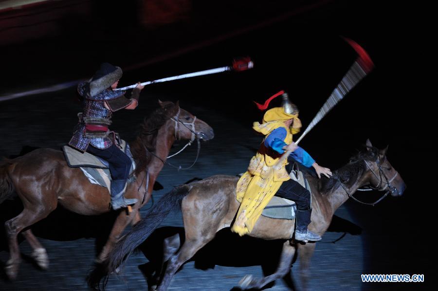 Kangxi ceremony is performed in Chengde, north China's Hebei Province, July 11, 2013. The show depicts the stories of Kangxi (1654-1722), the fourth emperor of ancient China's Qing Dynasty (1644-1911). During the reign of Kangxi, China witnessed a strong and prosperous period. Kangxi ceremony has run for 218 performances and has drwan nearly 200,000 viewers since its premiere in June 2011. (Xinhua/Wang Min)